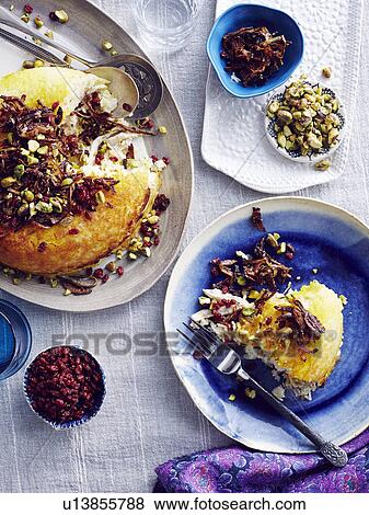 Stock Photo - "Still life of Iranian tahchin with rice, chicken and yogurt". Fotosearch