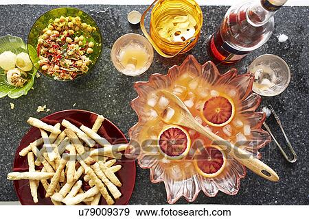 Still life of punch cocktail bowl with crisps and snacks View Large Photo Image Stock Photo - Still life of punch cocktail bowl with crisps and snacks. Fotosearch