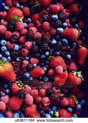 Picture - "Still life with abundance of strawberries, blackberries, blueberries, raspberries and cranberries". Fotosearch