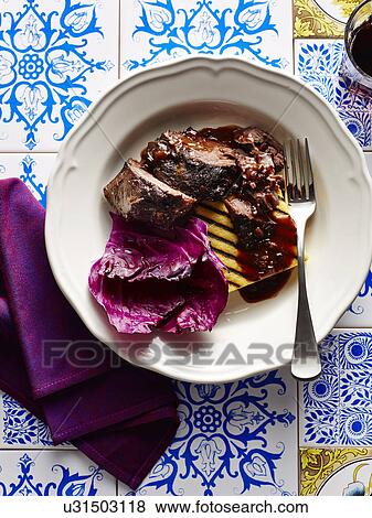 Still life with bowl of Italian braised veal cheeks and polenta View Large Photo Image Stock Photo - Still life with bowl of Italian braised veal cheeks and polenta. Fotosearch