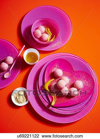 Stock Image - Still life with pink plates and sticky rice dumplings. Fotosearch