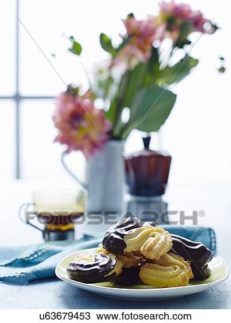 Stock Image - Still life with plate of Italian biscotti di esse. Fotosearch
