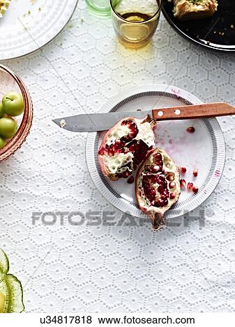 Still life with sliced pomegranate on plate View Large Photo Image Stock Photo - Still life with sliced pomegranate on plate. Fotosearch