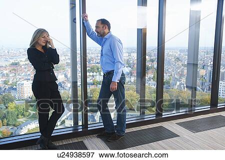 "Stressed businesswoman and man in skyscraper office, Brussels, Belgium" View Large Photo Image Stock Photo - "Stressed businesswoman and man in skyscraper office, Brussels, Belgium". Fotosearch