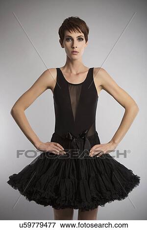 Studio portrait of woman wearing black tutu with hands on hips View Large Photo Image Stock Photo - Studio portrait of woman wearing black tutu with hands on hips. Fotosearch