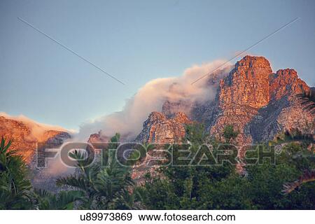 Stock Photo - "Table Mountain with 'Tablecloth' of cloud at sunset, Cape Town, South Africa". Fotosearch