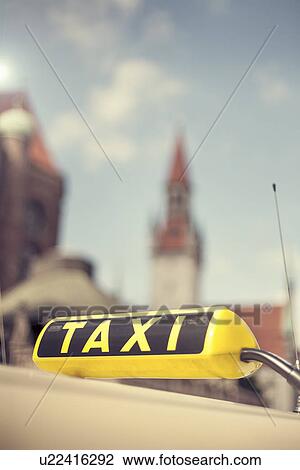 Stock Image - "Taxi sign, in front of Old Town Hall (Altes Rathaus) building, Marienplatz, Munich, Germany". Fotosearch