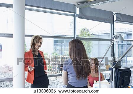 Three businesswomen discussing ideas at informal meeting View Large Photo Image Stock Photography - Three businesswomen discussing ideas at informal meeting. Fotosearch
