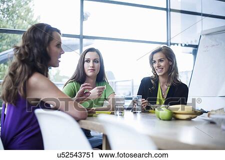 Three businesswomen eating lunch together View Large Photo Image Stock Image - Three businesswomen eating lunch together. Fotosearch