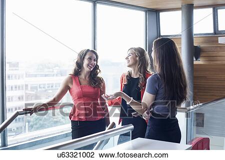 Three businesswomen having informal meeting View Large Photo Image Stock Image - Three businesswomen having informal meeting. Fotosearch