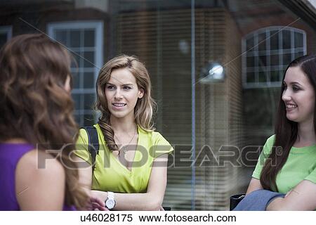 Stock Photography - "Three businesswomen talking, outside office". Fotosearch