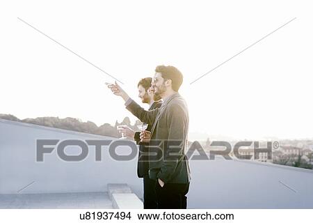 Picture - Three men making a toast at party. Fotosearch