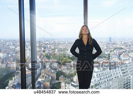 "Tired businesswoman in front of office window with Brussels cityscape, Belgium" View Large Photo Image Stock Photo - "Tired businesswoman in front of office window with Brussels cityscape, Belgium". Fotosearch