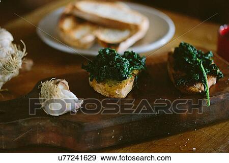 Tuscan bruschetta and cavolo nero with garlic bulb View Large Photo Image Stock Photo - Tuscan bruschetta and cavolo nero with garlic bulb. Fotosearch