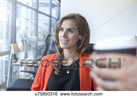 Two businesswomen having informal meeting in office View Large Photo Image Stock Photograph - Two businesswomen having informal meeting in office. Fotosearch