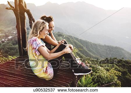 "Two young female friends on balcony over Lake Atitlan, Guatemala" View Large Photo Image Stock Photo - "Two young female friends on balcony over Lake Atitlan, Guatemala". Fotosearch