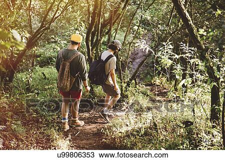 "Two young male friends hiking in rain forest at Lake Atitlan, Guatemala" View Large Photo Image Stock Image - "Two young male friends hiking in rain forest at Lake Atitlan, Guatemala". Fotosearch