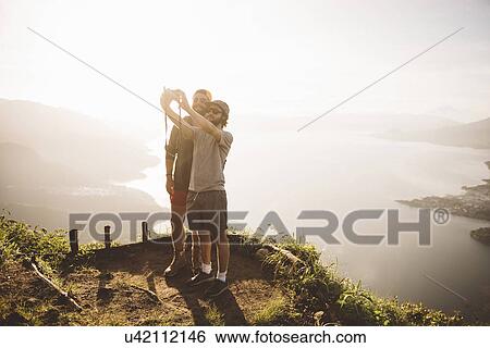 "Two young men taking selfie at Lake Atitlan on digital camera, Guatemala" View Large Photo Image Stock Photograph - "Two young men taking selfie at Lake Atitlan on digital camera, Guatemala". Fotosearch