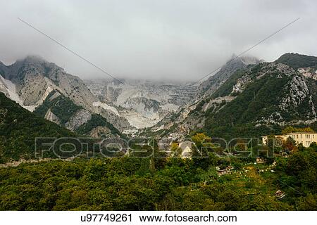 Stock Image - "View of low cloud over mountains, Massa-Carrara, Tuscany, Italy". Fotosearch