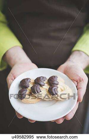 Waiter carrying plate of biscuits View Large Photo Image Stock Photography - Waiter carrying plate of biscuits. Fotosearch