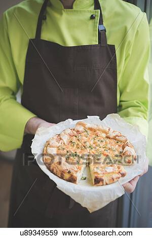 Waiter carrying plate of frittata View Large Photo Image Stock Photo - Waiter carrying plate of frittata. Fotosearch