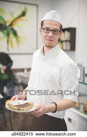 Waiter serving food at cafe View Large Photo Image Stock Photography - Waiter serving food at cafe. Fotosearch