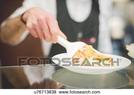 Waiter serving quiche over the counter View Large Photo Image Stock Photo - Waiter serving quiche over the counter. Fotosearch