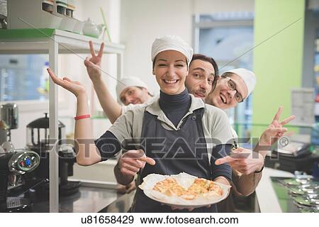 "Waitress carrying plate of food, colleagues making fun behind" View Large Photo Image Stock Photo - "Waitress carrying plate of food, colleagues making fun behind". Fotosearch
