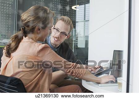 Woman and man chatting in office meeting View Large Photo Image Stock Image - Woman and man chatting in office meeting. Fotosearch