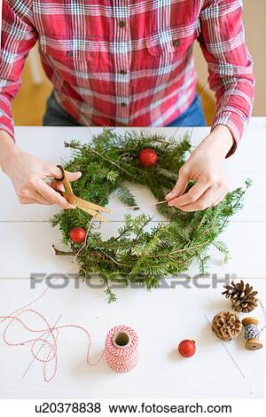 Woman decorating Christmas wreath View Large Photo Image Stock Photo - Woman decorating Christmas wreath. Fotosearch
