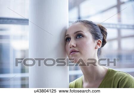 Woman leaning against pillar View Large Photo Image Stock Photography - Woman leaning against pillar. Fotosearch