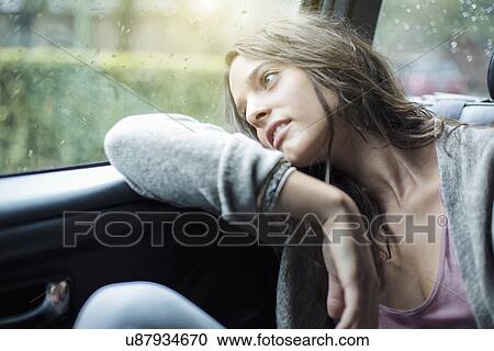 Woman looking out of car window View Large Photo Image Stock Image - Woman looking out of car window. Fotosearch