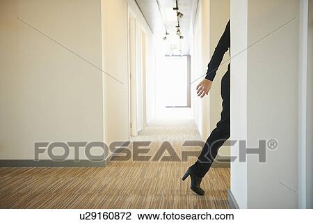 Woman walking across corridor View Large Photo Image Stock Image - Woman walking across corridor. Fotosearch