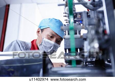 Picture - "Worker at e-cigarettes battery factory, Guangdong, China". Fotosearch