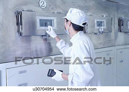 Picture - "Worker at e-cigarettes battery factory, Guangdong, China". Fotosearch