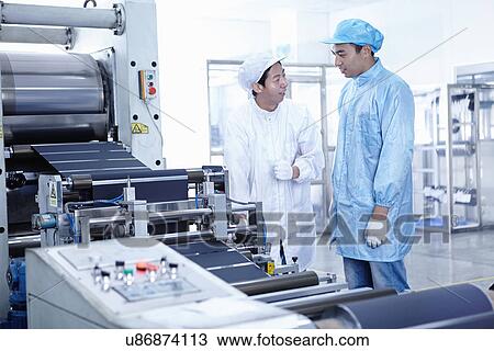 Stock Image - "Worker at e-cigarettes battery factory, Guangdong, China". Fotosearch