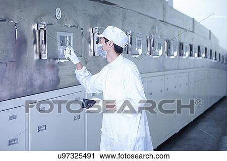 Stock Image - "Worker at e-cigarettes battery factory, Guangdong, China". Fotosearch