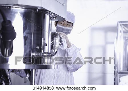 Stock Photo - "Worker at e-cigarettes battery factory, Guangdong, China". Fotosearch