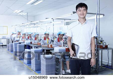 Stock Photo - "Worker at e-cigarettes battery factory, Guangdong, China". Fotosearch