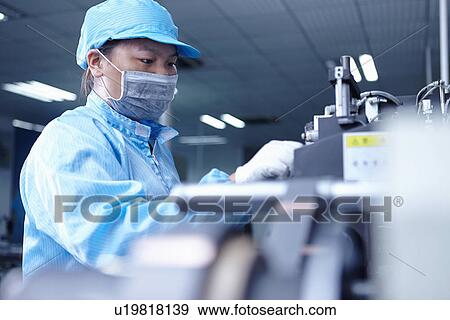 Stock Photo - "Worker at e-cigarettes battery factory, Guangdong, China". Fotosearch