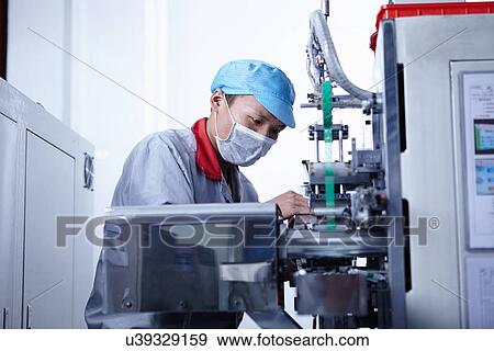 "Worker at e-cigarettes battery factory, Guangdong, China" View Large Photo Image Stock Photo - "Worker at e-cigarettes battery factory, Guangdong, China". Fotosearch