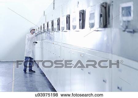 Stock Photo - "Worker at e-cigarettes battery factory, Guangdong, China". Fotosearch