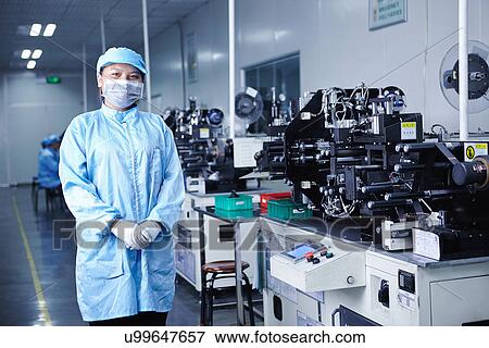 Stock Photo - "Worker at e-cigarettes battery factory, Guangdong, China". Fotosearch