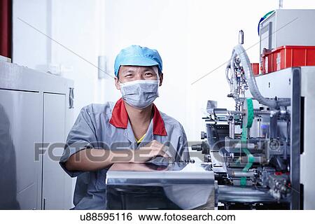 "Worker at e-cigarettes battery factory, Guangdong, China" View Large Photo Image Stock Photograph - "Worker at e-cigarettes battery factory, Guangdong, China". Fotosearch