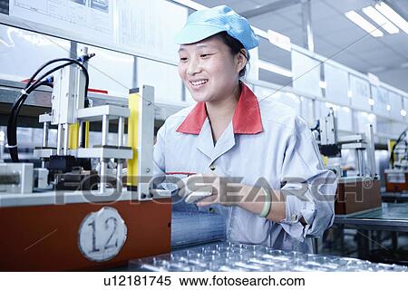 Stock Photography - "Worker at e-cigarettes battery factory, Guangdong, China". Fotosearch