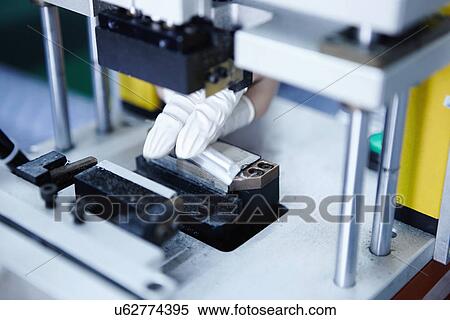 Stock Photography - "Worker at e-cigarettes battery factory, Guangdong, China". Fotosearch