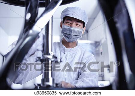 Stock Photography - "Worker at e-cigarettes battery factory, Guangdong, China". Fotosearch