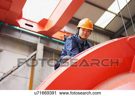 "Worker in crane manufacturing facility, China" View Large Photo Image Stock Image - "Worker in crane manufacturing facility, China". Fotosearch