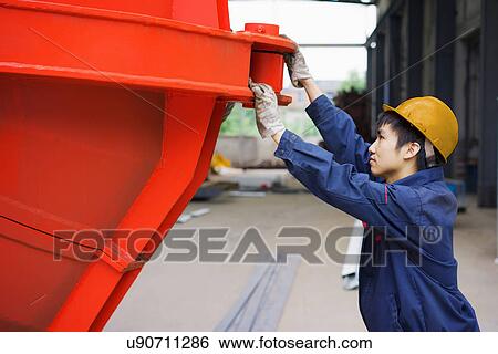 "Worker in crane manufacturing facility, China" View Large Photo Image Stock Photograph - "Worker in crane manufacturing facility, China". Fotosearch