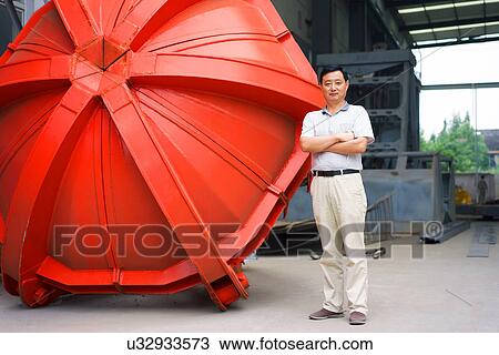 "Worker standing beside part in crane manufacturing facility, China" View Large Photo Image Stock Image - "Worker standing beside part in crane manufacturing facility, China". Fotosearch